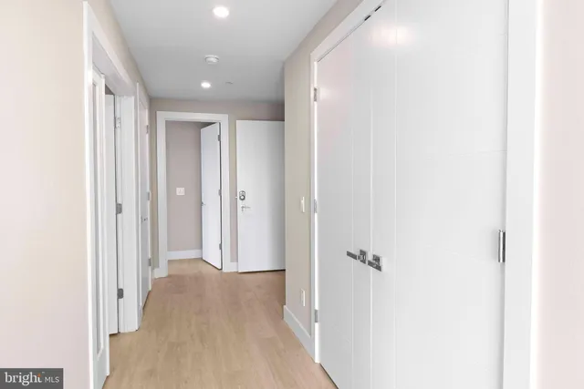 a view of a hallway with wooden floor