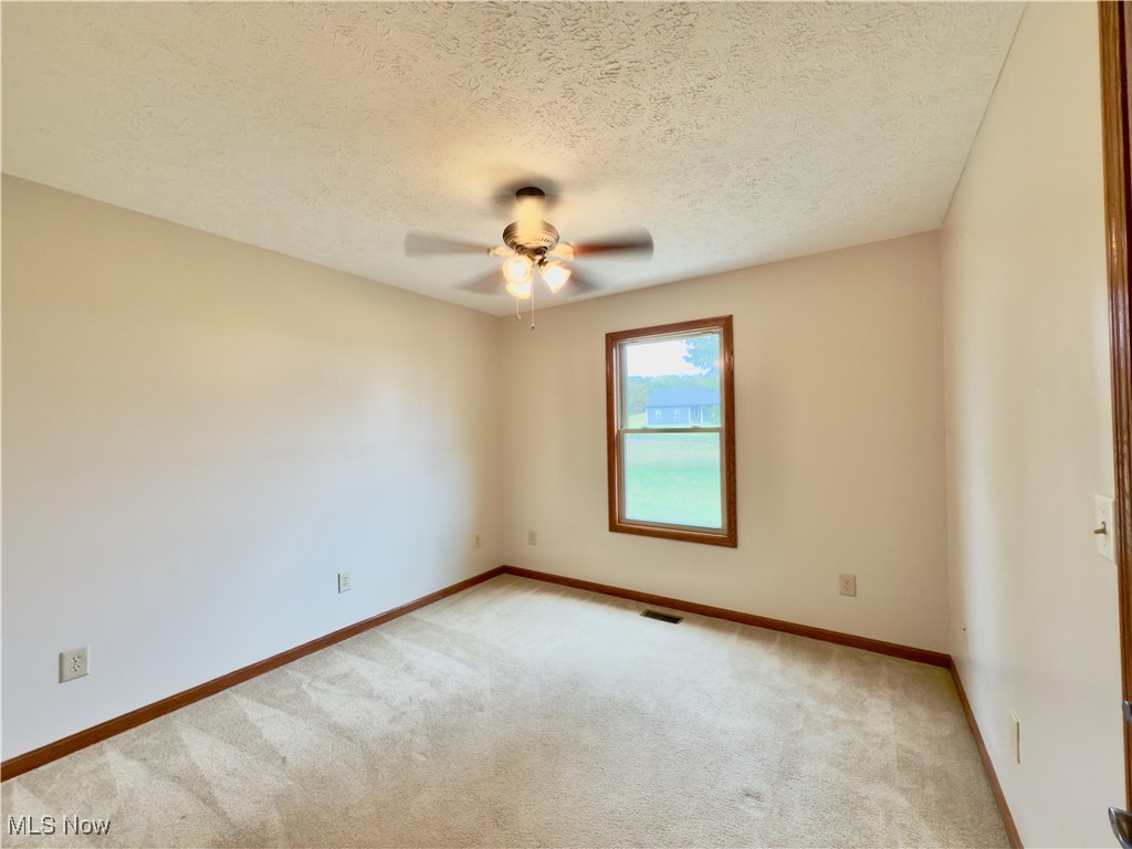 2109 Bell Road Vincent, OH 45784 - Photo 17 of 49 Unfurnished room featuring a textured ceiling, carpet flooring, and ceiling fan