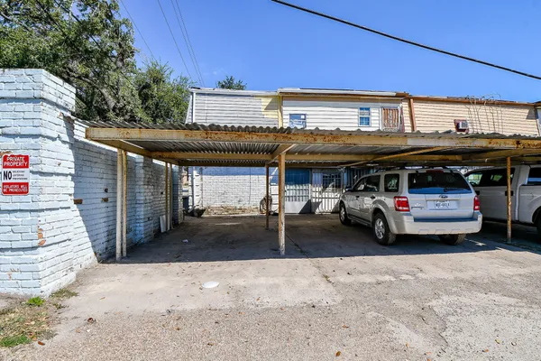 a view of a car park in front of retail shop