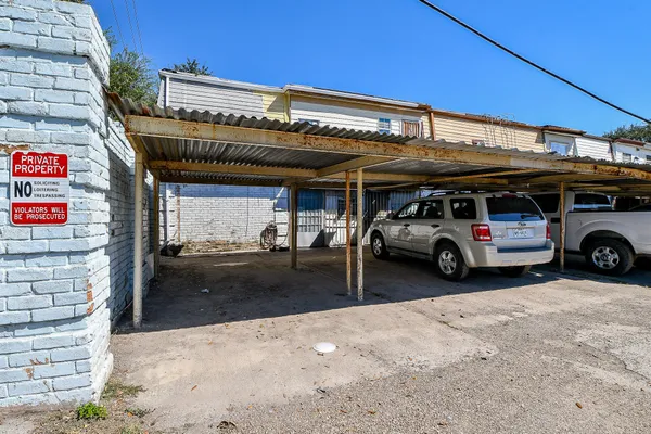 a view of a cars park in front of a building