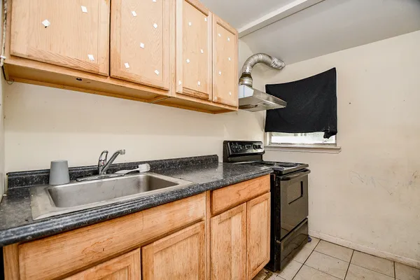 a kitchen with stainless steel appliances granite countertop a sink and a stove