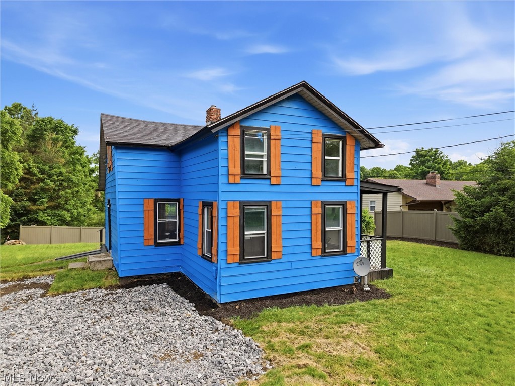 5860 Kirk Road Canfield, OH 44406 - Photo 3 of 17 Two-story residence featuring blue siding, a dark shingle roof, and wood-finish shutters