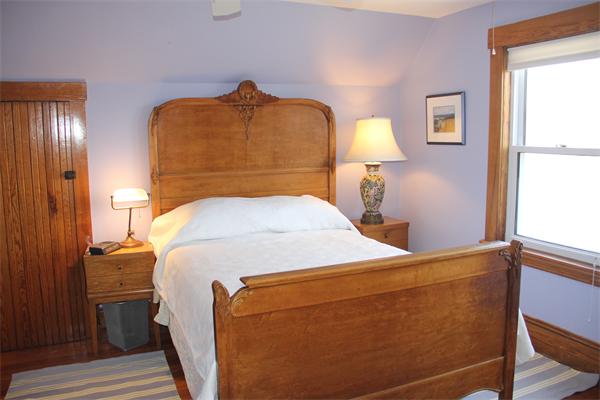 8 Salt Island Road Gloucester, MA 01930 - Photo 18 of 20 a bedroom with a bed and a lamp on dresser