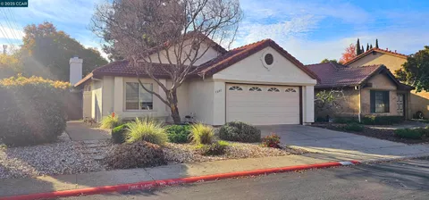 a view of a house with a yard and street