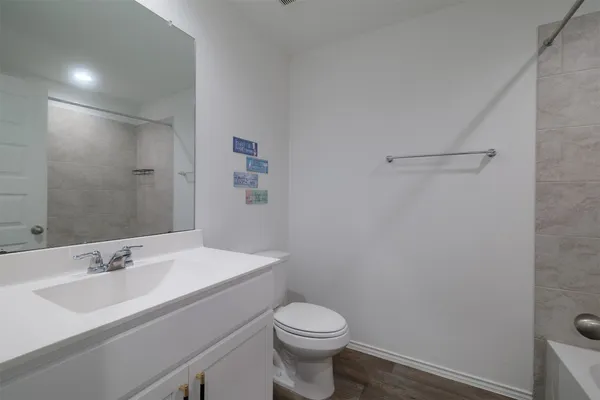 a bathroom with a sink toilet and a mirror