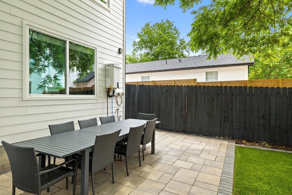 1182 Ridgeway Drive, Unit A Austin, TX 78702 - Photo 34 of 35 a backyard of a house with table and chairs