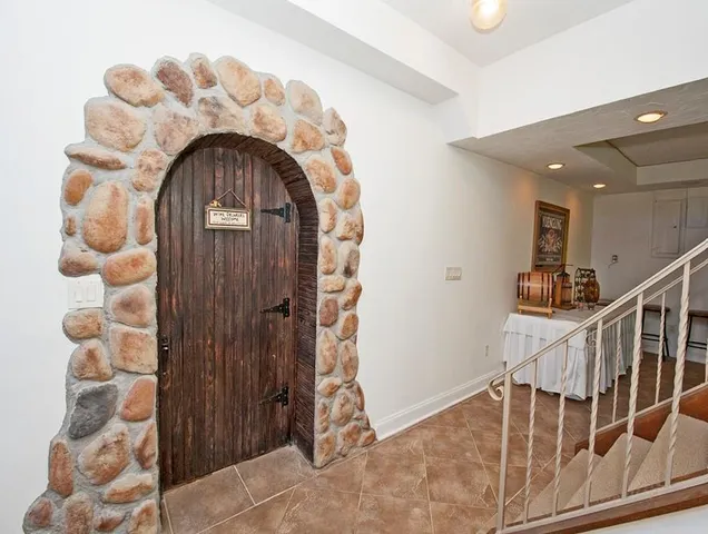 a dining room with furniture a rug and a chandelier