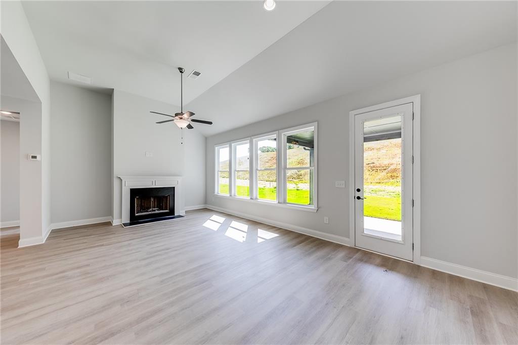 114 Classic Overlook Homer, GA 30547 - Photo 12 of 39 an empty room with windows and fireplace