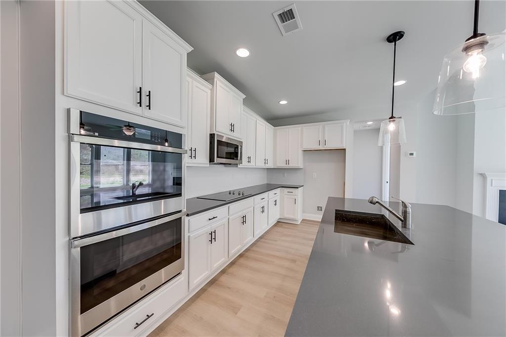 114 Classic Overlook Homer, GA 30547 - Photo 17 of 39 a large kitchen with stainless steel appliances granite countertop a stove a sink and white cabinets