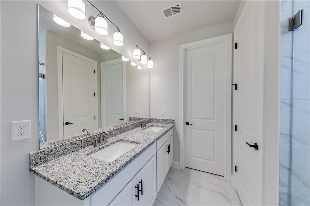114 Classic Overlook Homer, GA 30547 - Photo 20 of 39 a bathroom with a granite countertop sink and a mirror