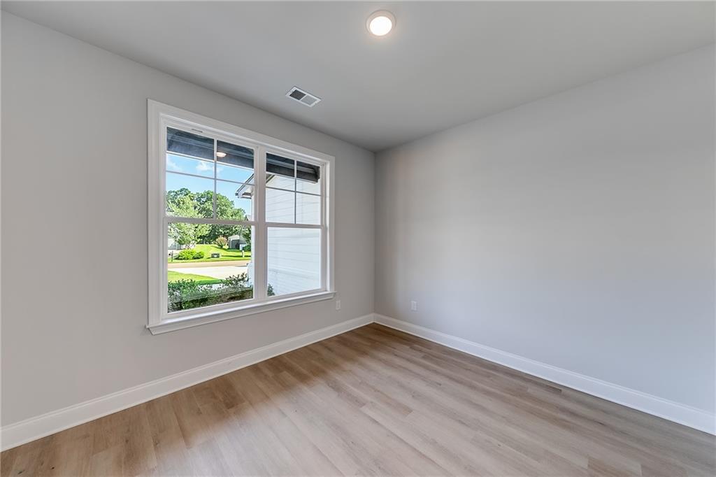 114 Classic Overlook Homer, GA 30547 - Photo 9 of 39 an empty room with wooden floor and windows