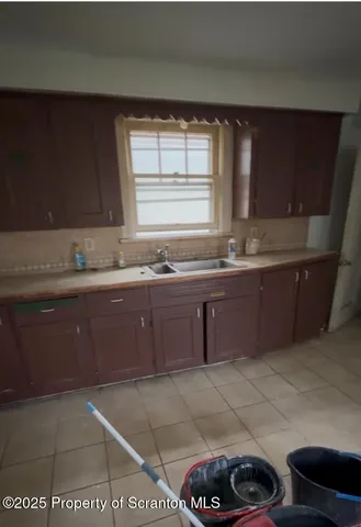 a kitchen with a sink a stove and cabinets