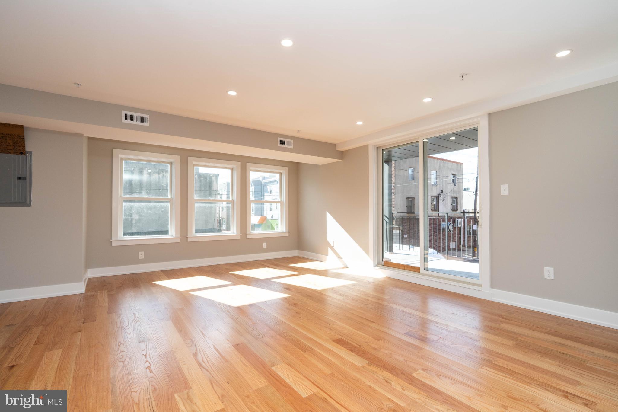 1711 South 5th Street, Unit 3 Philadelphia, PA 19148 - Photo 3 of 9 a view of empty room with wooden floor and fan