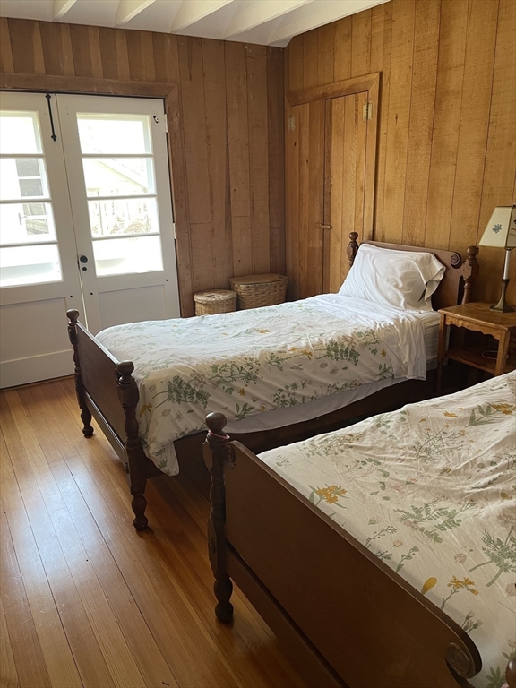 45 Old Cove Road Duxbury, MA 02332 - Photo 11 of 12 a bedroom with a bed and wooden floor