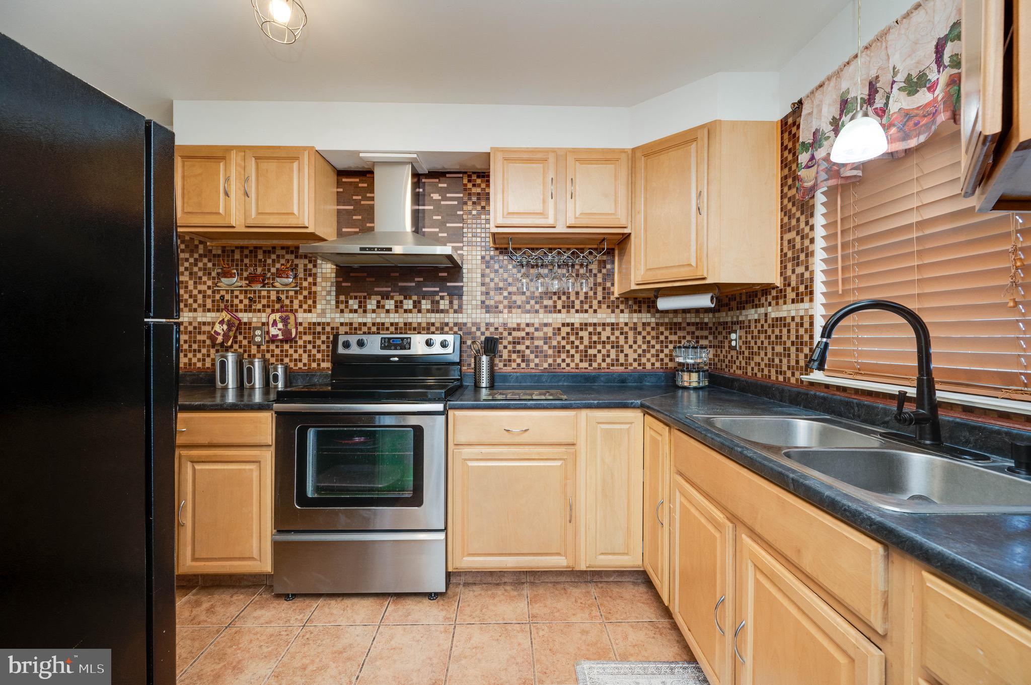 11 Nottingham Court Reading, PA 19601 - Photo 8 of 29 a kitchen with stainless steel appliances granite countertop a stove a sink and a microwave