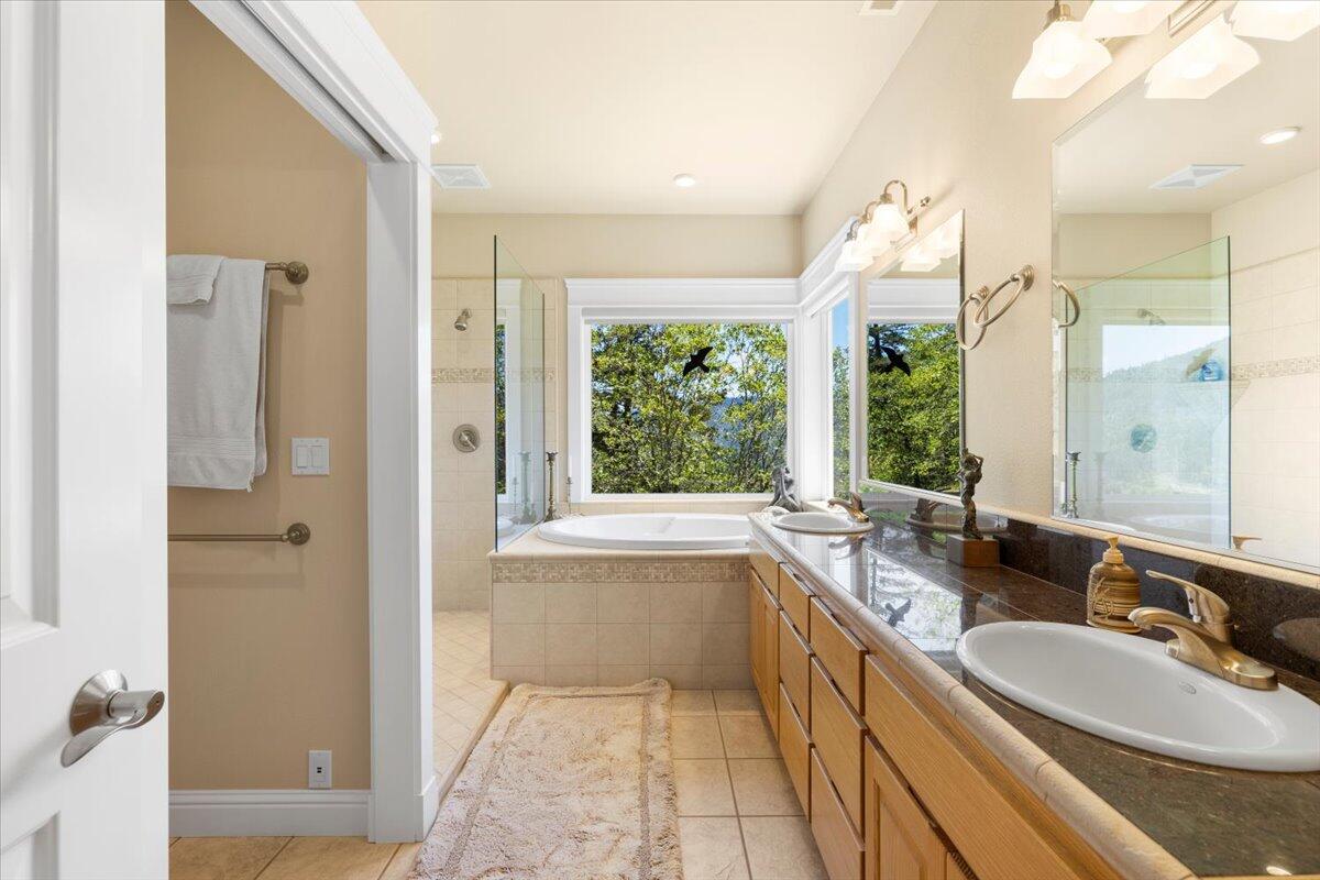 3344 Pearce Park Road Grants Pass, OR 97526 - Photo 38 of 65 Dual sink vanity with extra storage. Sep toilet room -- with door and casement window.