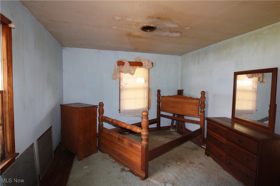 5084 West Fremont Road Port Clinton, OH 43452 - Photo 17 of 19 Bedroom with unfinished concrete flooring and a ceiling fan