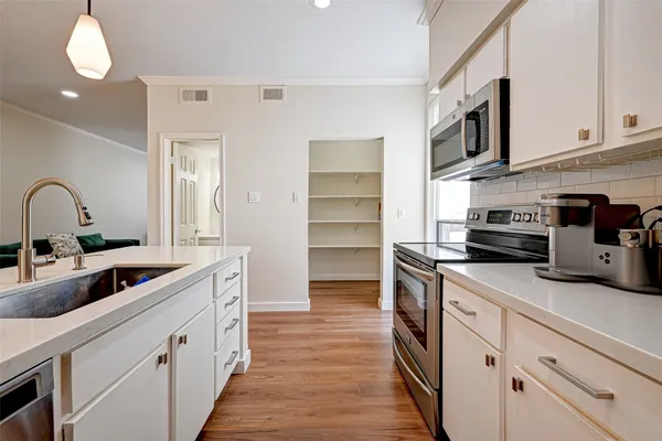 a kitchen with stainless steel appliances granite countertop a sink and cabinets