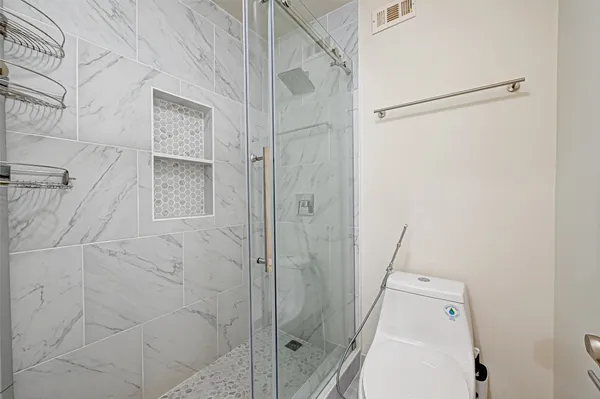 a bathroom with a shower and a toilet