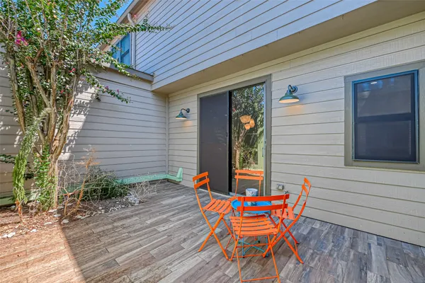 a backyard of a house with table and chairs