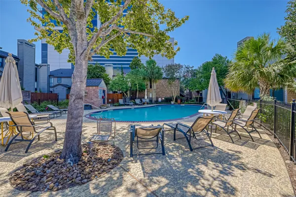 a view of a chairs and table in backyard