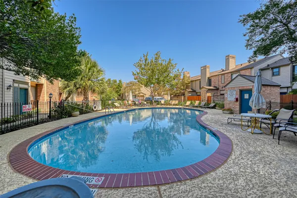 a view of a swimming pool with sitting area