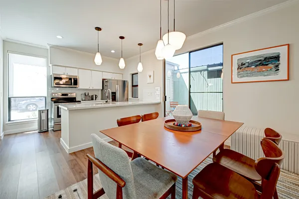 a view of a dining room with furniture and wooden floor