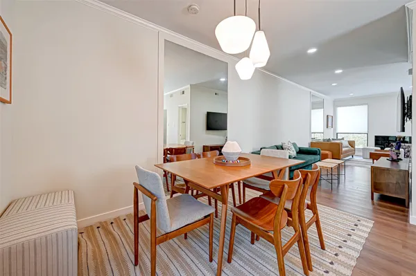 a view of a dining room with furniture and wooden floor