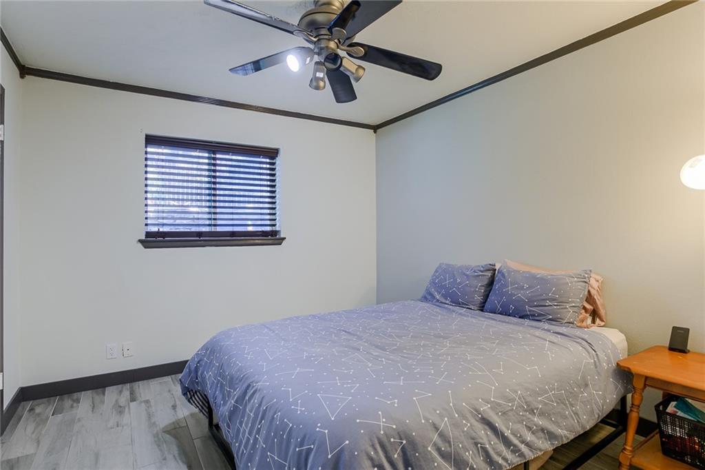 620 South 1st Street, Unit 107 Austin, TX 78704 - Photo 13 of 22 a bedroom with a bed and wooden floor