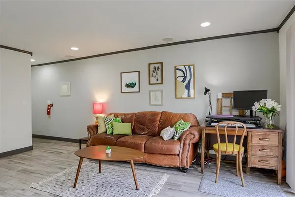 a living room with furniture and a bookshelf