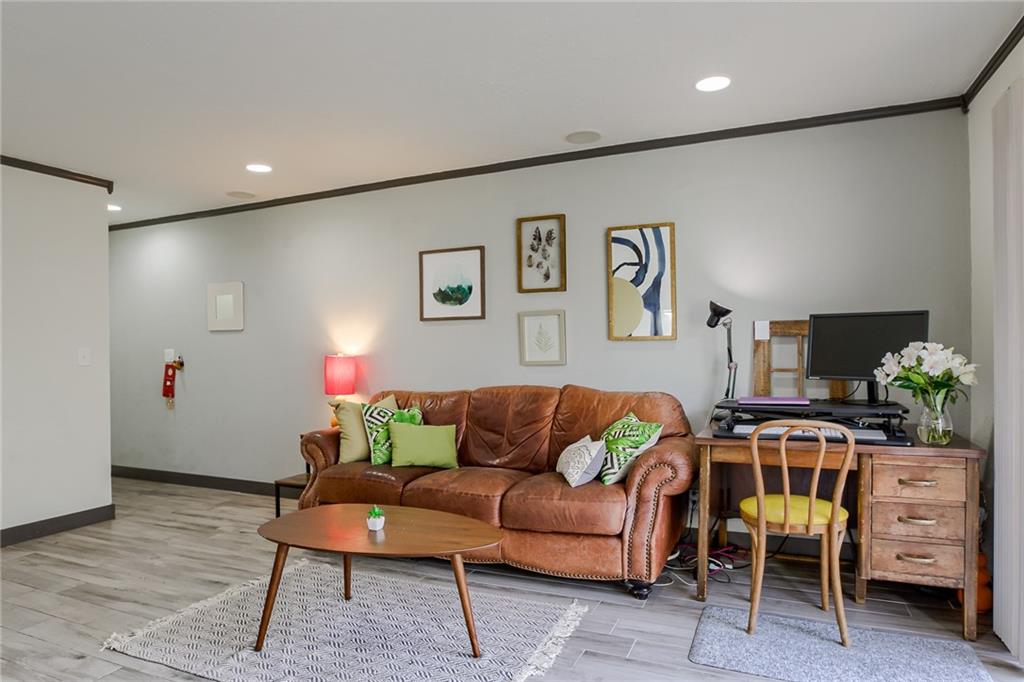 620 South 1st Street, Unit 107 Austin, TX 78704 - Photo 5 of 22 a living room with furniture and a bookshelf