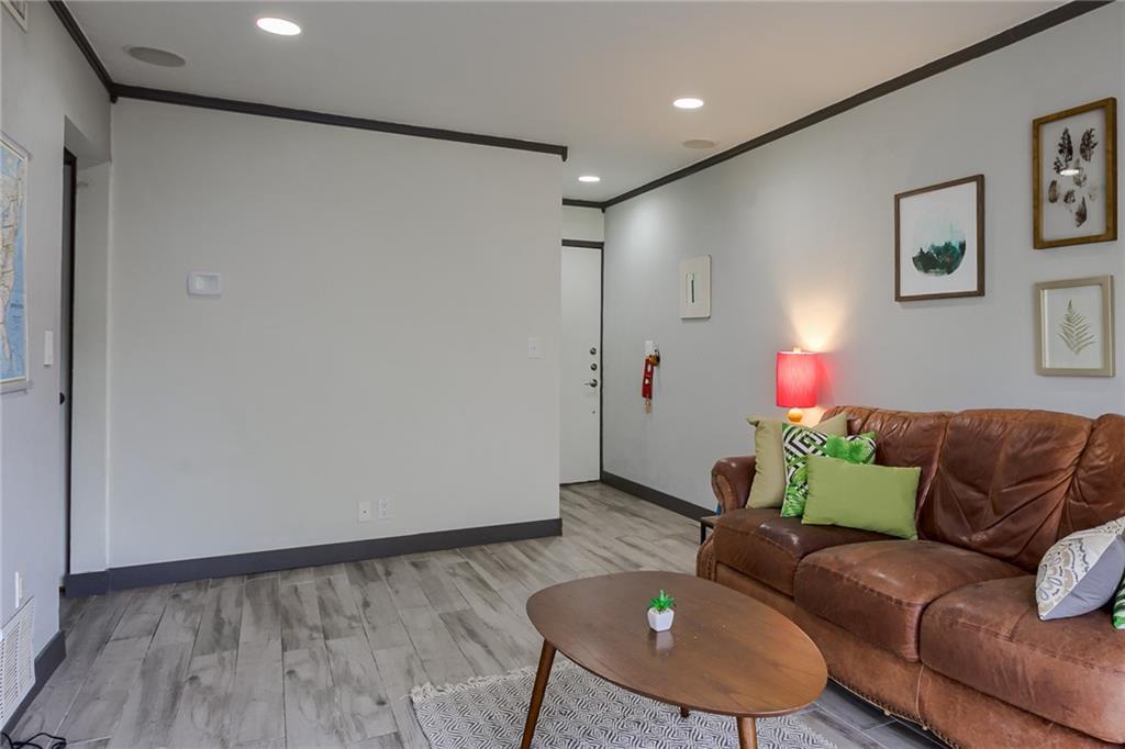 620 South 1st Street, Unit 107 Austin, TX 78704 - Photo 6 of 22 a living room with furniture and a wooden floor