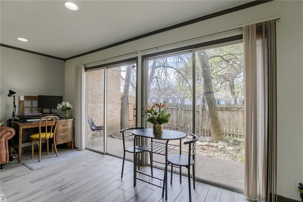 620 South 1st Street, Unit 107 Austin, TX 78704 - Photo 7 of 22 a workspace with wooden floor and furniture