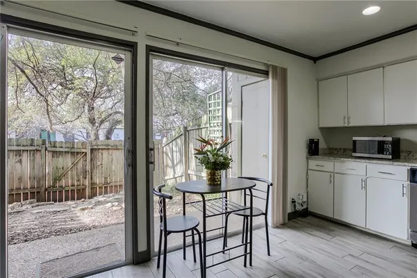 a kitchen with a table chairs and entryway