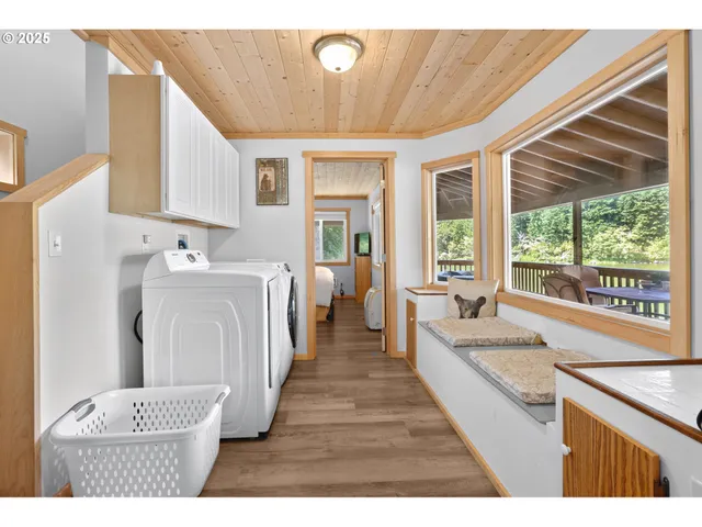 a large white kitchen with a large window