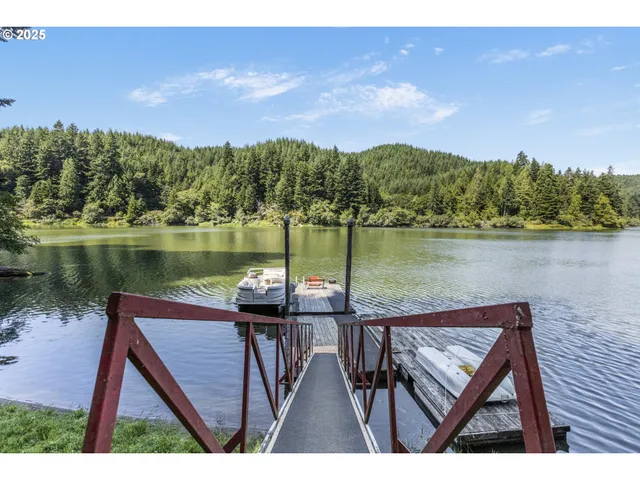 a view of a chairs on the deck in front of lake