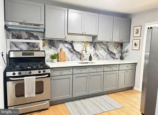 a kitchen with white cabinets and appliances