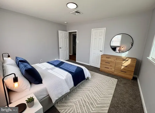 a bedroom with a bed and dresser