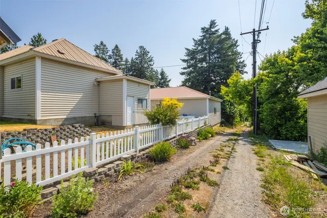 a view of a house with a yard and sitting area