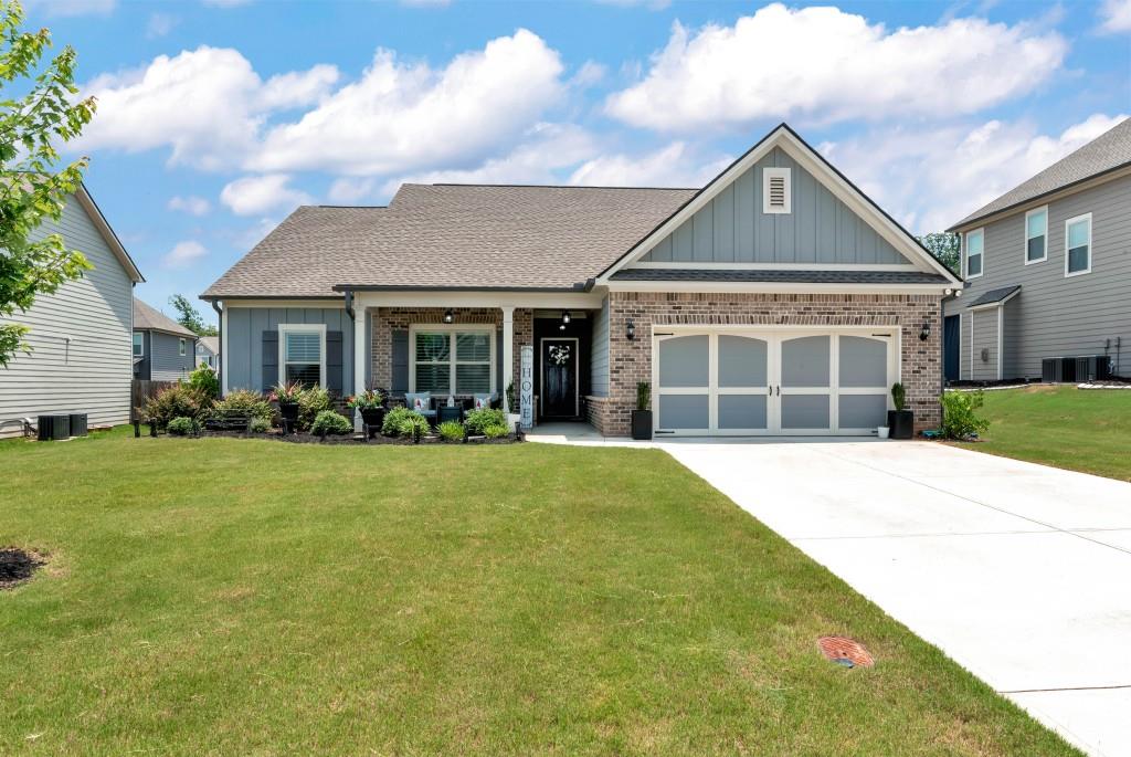 1311 Calgary Lake Drive Winder, GA 30680 - Photo 1 of 45 a front view of a house with a yard