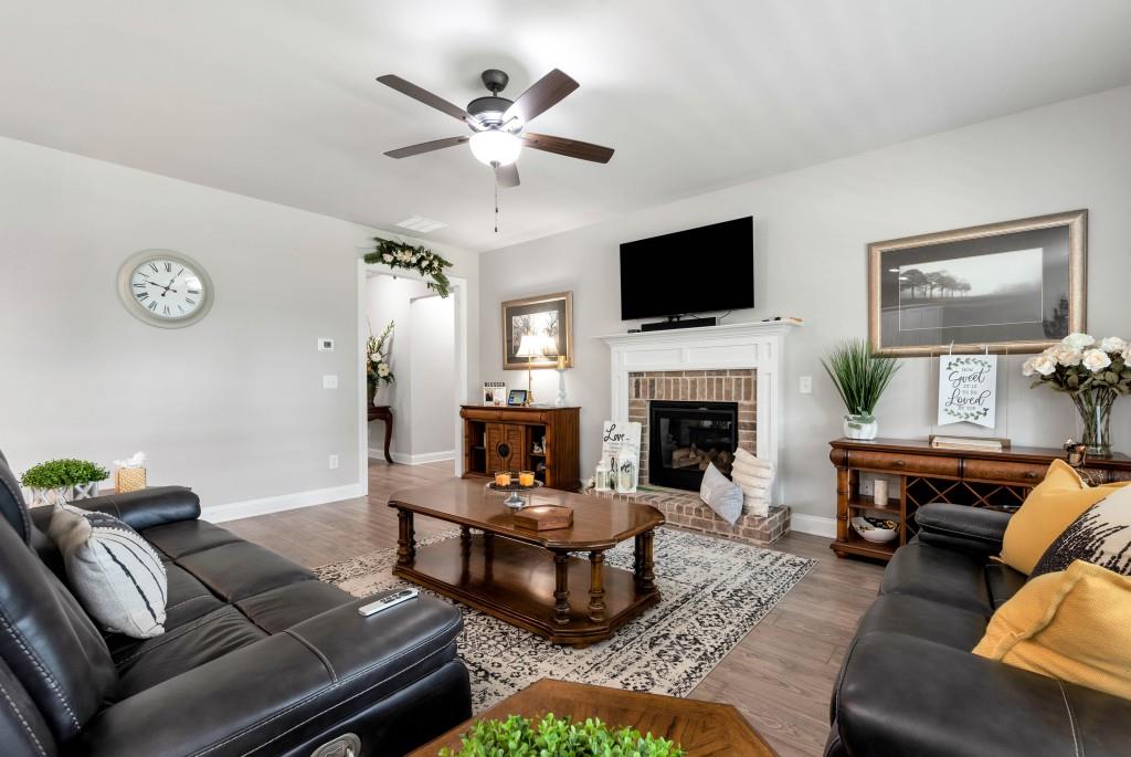 1311 Calgary Lake Drive Winder, GA 30680 - Photo 11 of 45 a living room with furniture and a fireplace