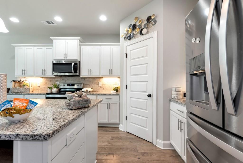 1311 Calgary Lake Drive Winder, GA 30680 - Photo 14 of 45 a kitchen with granite countertop stainless steel appliances and counter space