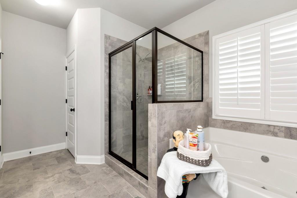1311 Calgary Lake Drive Winder, GA 30680 - Photo 25 of 45 a bathroom with a bathtub and a shower