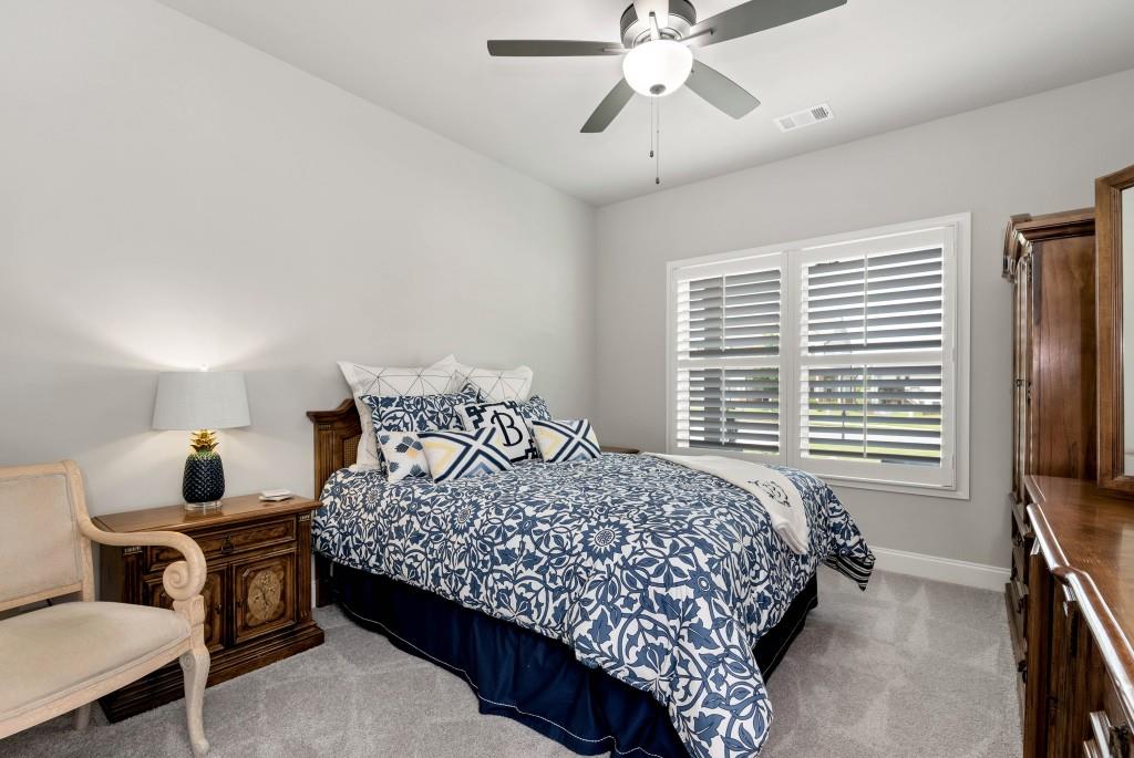 1311 Calgary Lake Drive Winder, GA 30680 - Photo 29 of 45 a bedroom with a bed a window and a flat screen television