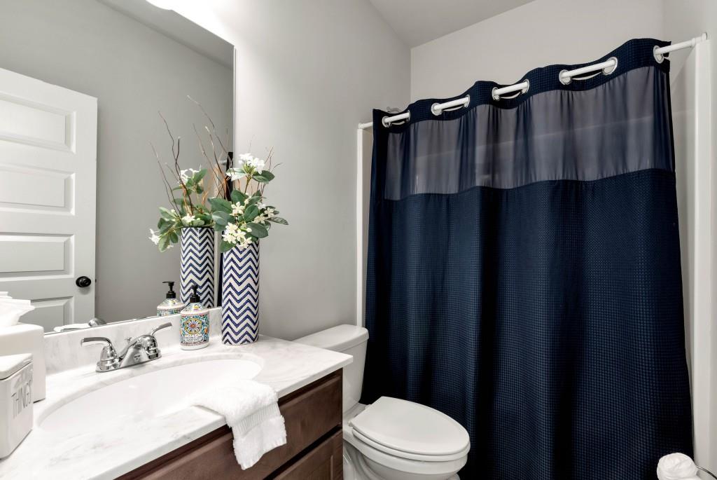 1311 Calgary Lake Drive Winder, GA 30680 - Photo 31 of 45 a bathroom with a sink vanity mirror and toilet