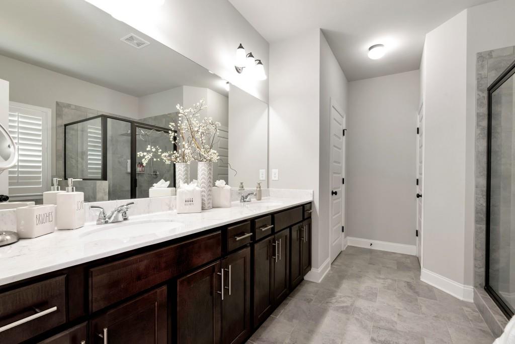 1311 Calgary Lake Drive Winder, GA 30680 - Photo 35 of 45 a bathroom with a double vanity sink and a mirror