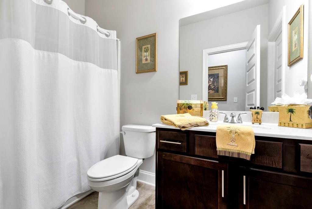 1311 Calgary Lake Drive Winder, GA 30680 - Photo 38 of 45 a bathroom with a sink toilet and mirror