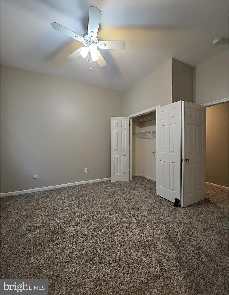 2128 Fleet Street, Unit 1 Baltimore, MD 21231 - Photo 6 of 11 a view of a livingroom with a refrigerator a ceiling fan and a kitchen view