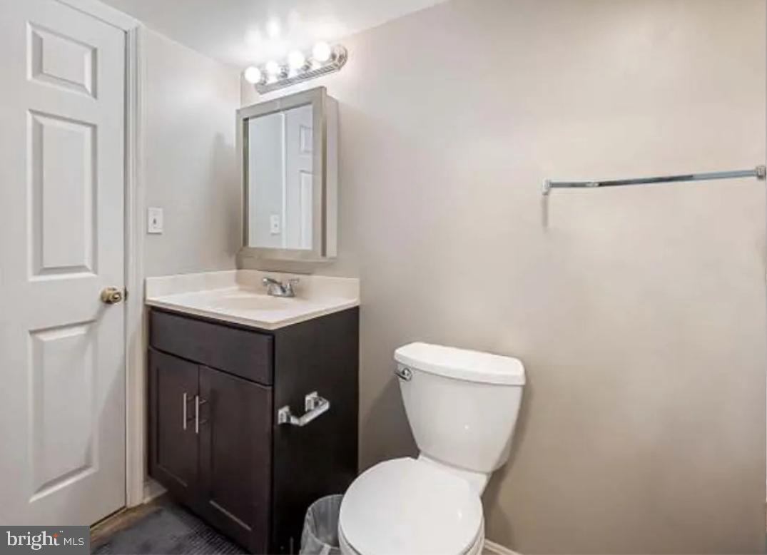 2128 Fleet Street, Unit 1 Baltimore, MD 21231 - Photo 7 of 11 a bathroom with a toilet sink and mirror