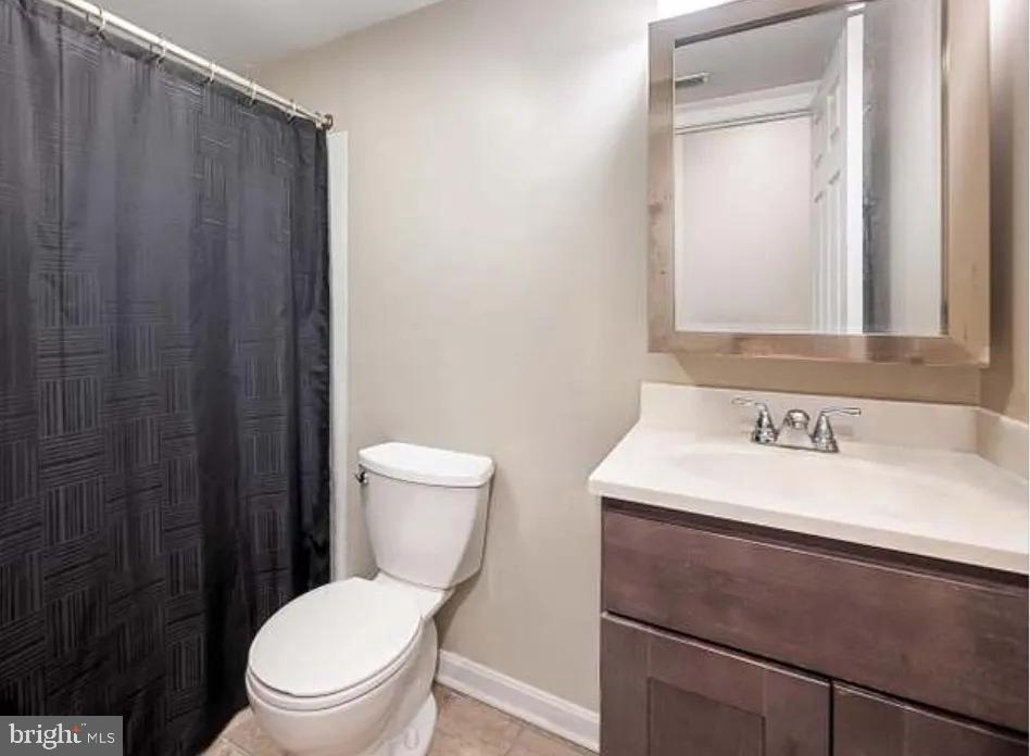 2128 Fleet Street, Unit 1 Baltimore, MD 21231 - Photo 10 of 11 a bathroom with a sink a toilet and a mirror